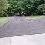 This driveway in Ada was up a steep slope.  We repaired the drainage issues, compacted the base with our steel vibrating roller and installed a cap of crushed asphalt.  See Dan's testimonial on our TESTIMONIALS WEBPAGE.