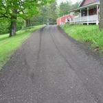 AFTER - Alto, MI Finished grade on 350' driveway 3-4" of Recycled Asphalt. . . green product, packs extremely hard, less dusty and looks like a paved surface after rolling.